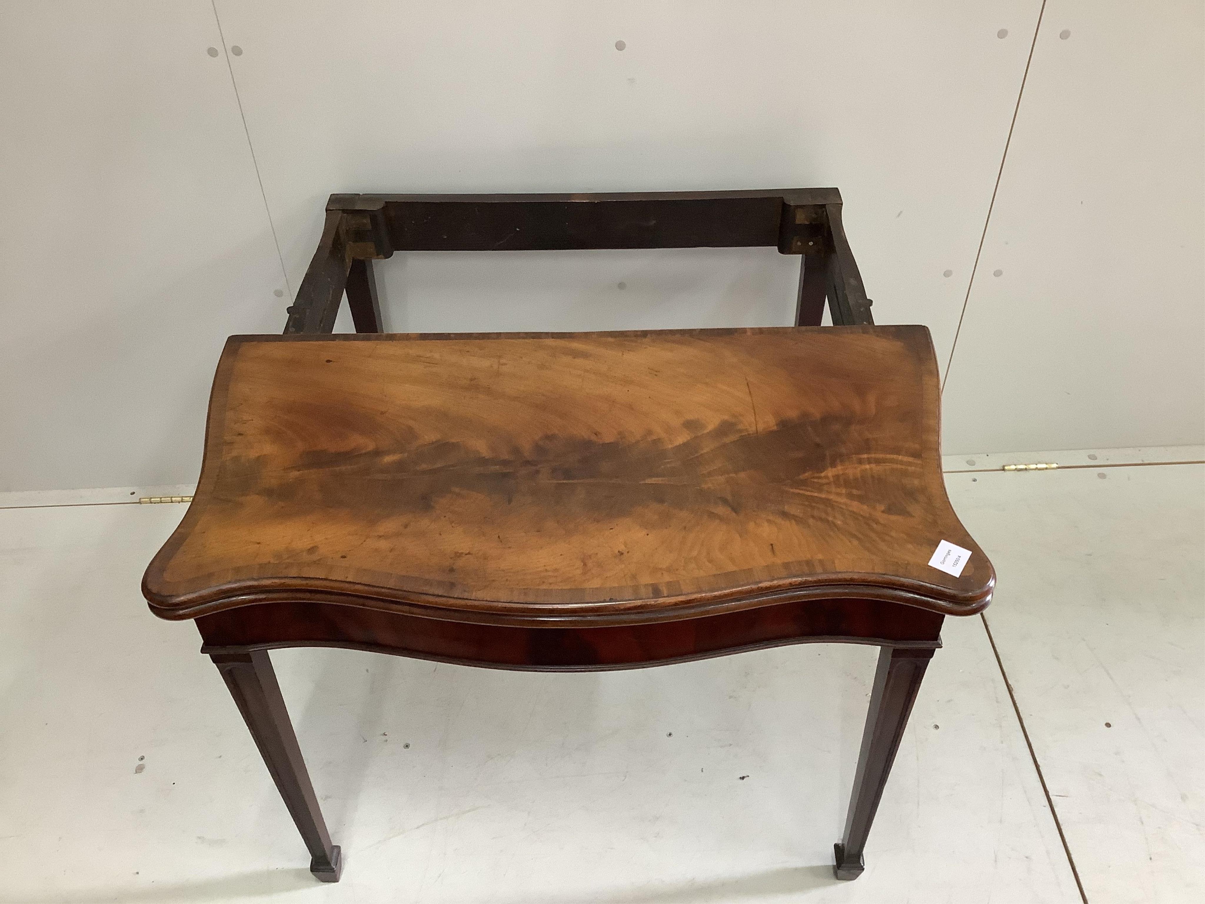 A George III banded serpentine mahogany 'concertina action' folding card table, width 88cm, depth 44cm, height 73cm. Condition - fair